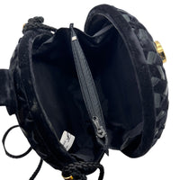 Open view of Vintage black round velvet and satin weave small crossbody handbag with cord strap displayed on white background.