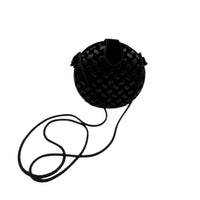 Standing up view of Vintage black round velvet and satin weave small crossbody handbag with cord strap displayed on white background.