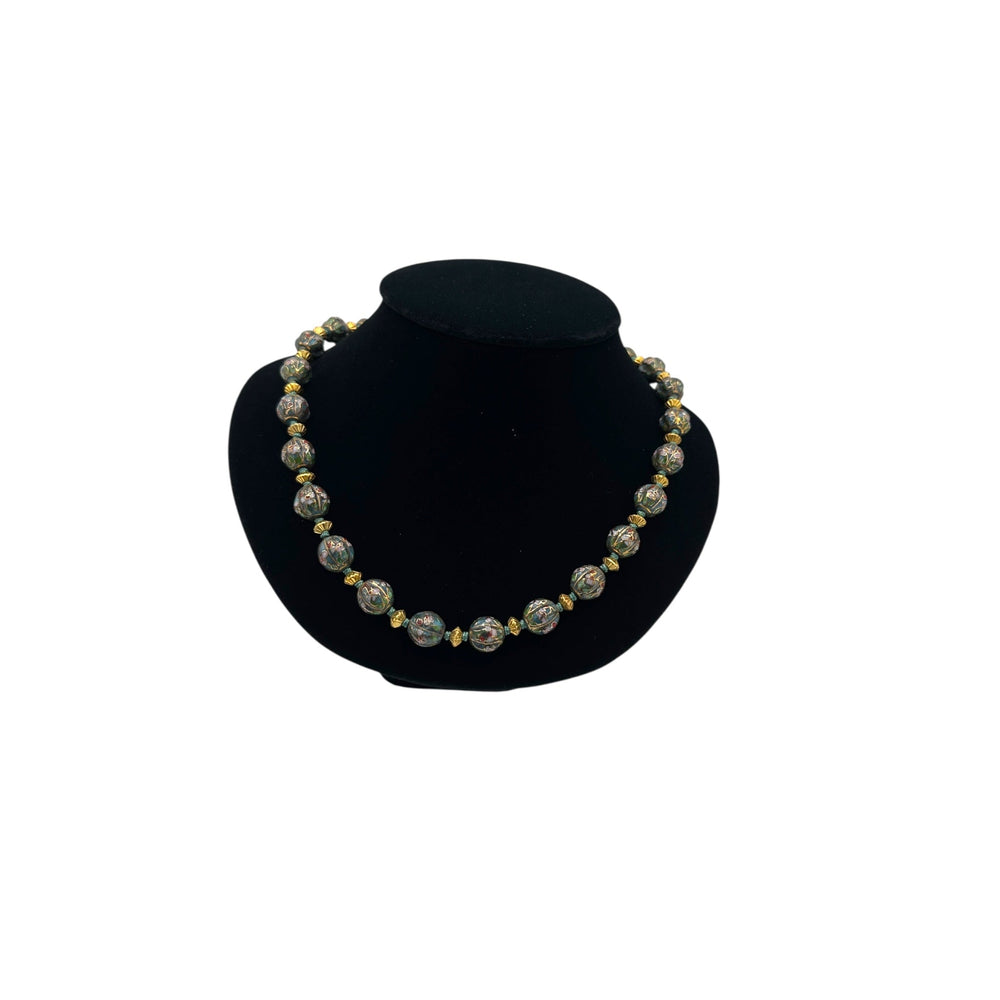Vintage green and gold floral cloisonné bead hand-knotted necklace with scalloped enamel design displayed on black bust.