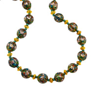 Bottom view of Vintage green and gold floral cloisonné bead hand-knotted necklace with scalloped enamel design displayed on black bust.