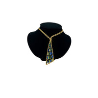 Vintage gold chain tie necklace with blue and green marquise rhinestone pendant on black bust.