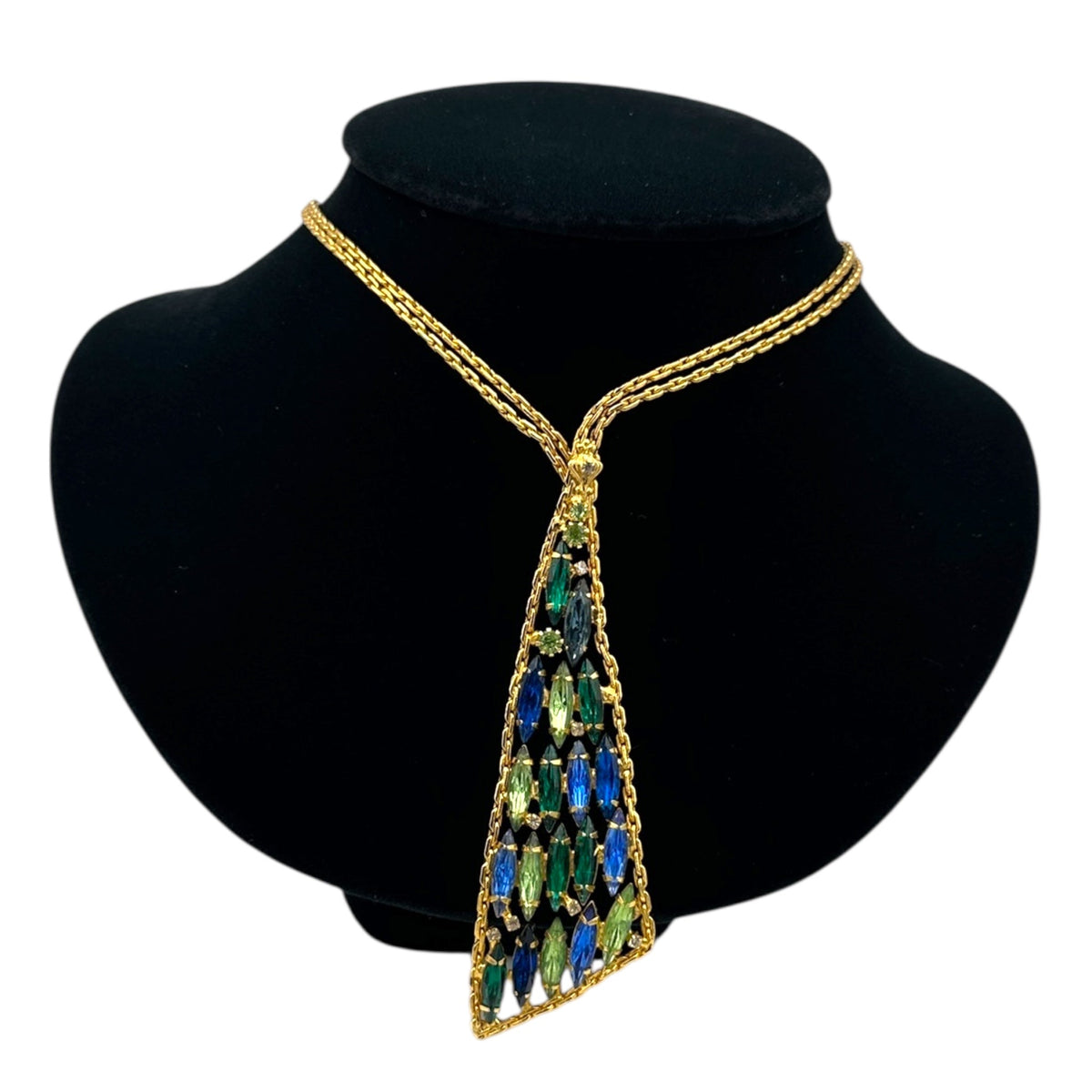Close up view of Vintage gold chain tie necklace with blue and green marquise rhinestone pendant on black bust.