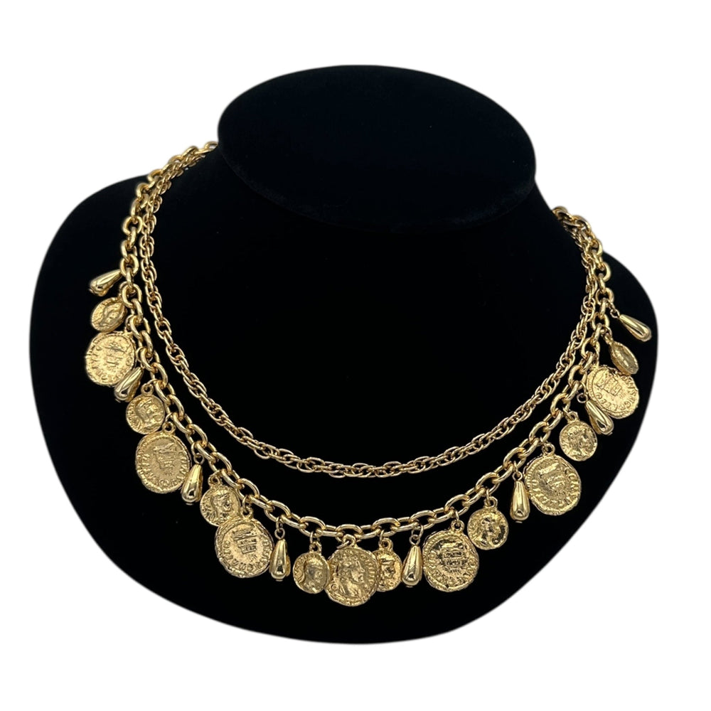 Close up view of Vintage gold layered Roman coin charm necklace with medallions and teardrop accents displayed on black velvet bust.