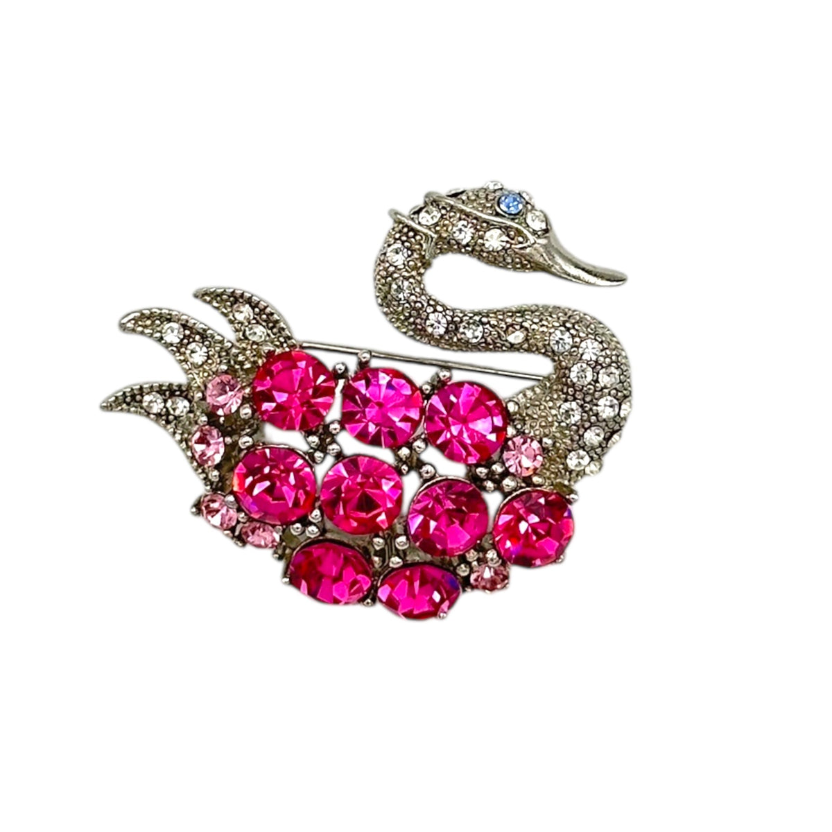 Close up of Vintage silver swan brooch with large round pink rhinestones on white background.