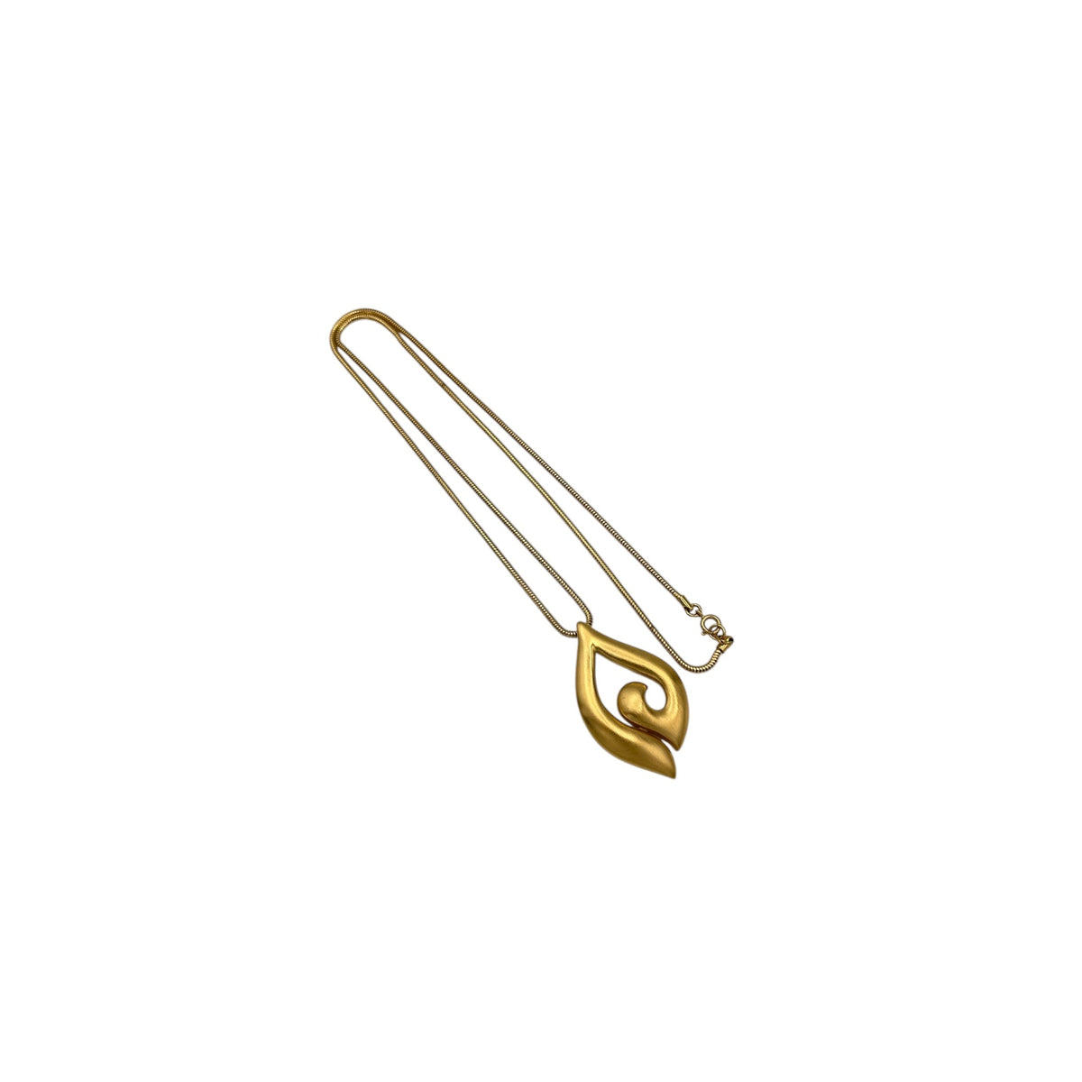 Vintage Trifari gold modernist pendant necklace on long snake chain on white background.