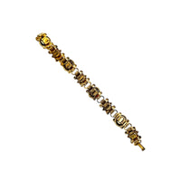 Back view of Vintage Victorian Revival gold tone book chain bracelet with ruby red glass cabochon centerpiece displayed on white background.